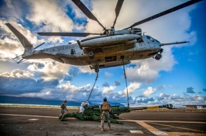U.S. Marines lift an artillery piece with a helicopter