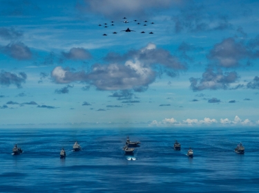 Eleven U.S. vessels steam in formation while U.S. Navy and Department of the Air Force aircraft fly overhead during the Valiant Shield 2020 exercise