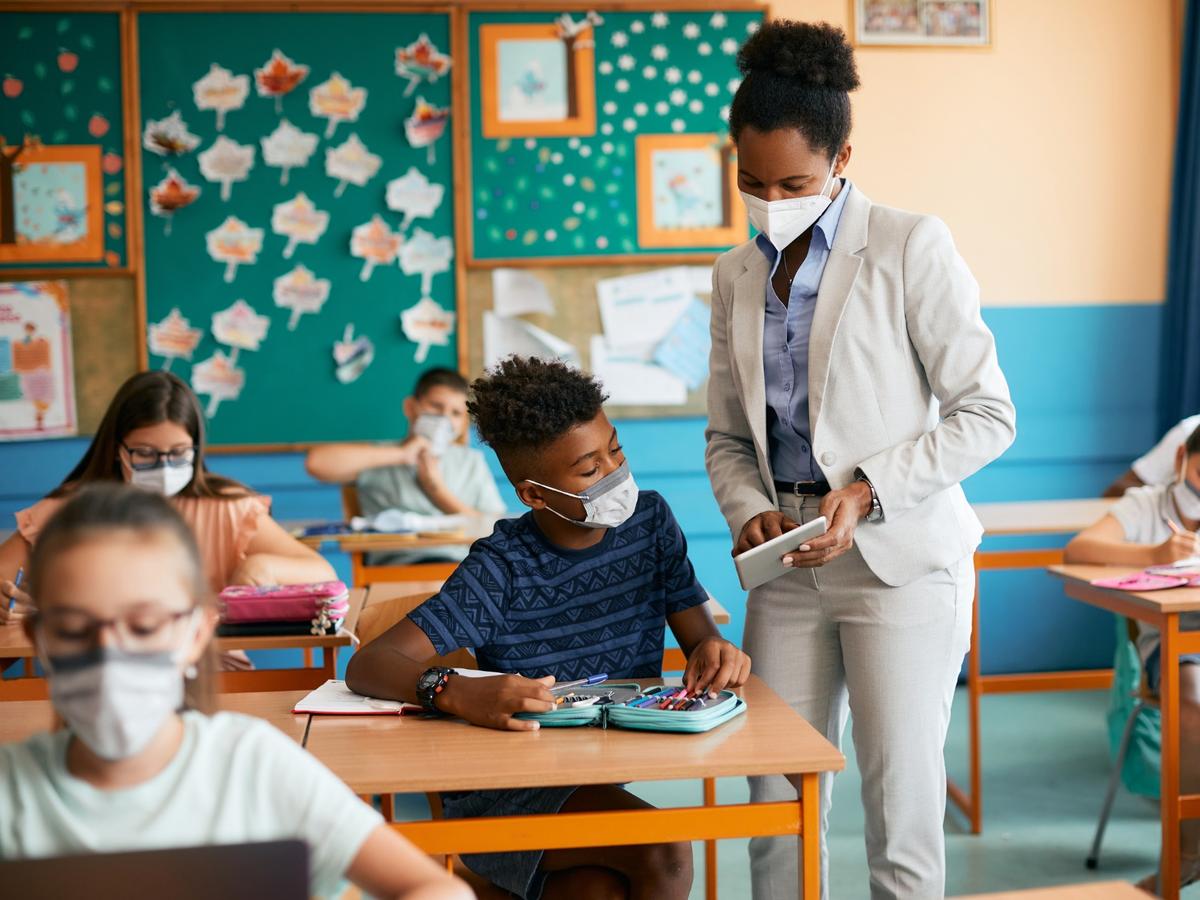 teacher helping student