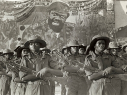 Fighters of the anti-government guerilla group UNITA parade under a portrait of their leader Jonas Savimbi, November 12, 1985, marking the 10th anniversary of Angolan Independence from Portugal