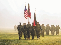 The 1st Battalion, 82nd Field Artillery Regiment, 1st Armored Brigade Combat Team, 1st Cavalry Division, color guard marches off Tower Barracks parade field after a battalion reenlistment ceremony at Grafenwoehr Training Area, Germany, Dec. 28, 2018, photo by Sgt. Jamar Marcel Pugh/U.S. Army National Guard