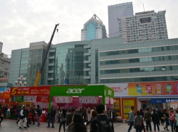 People shopping at the electronic market outside The SEG Plaza, a skyscraper named after the Shenzhen Electronics Group, in Shenzhen, China, February 1, 2015
