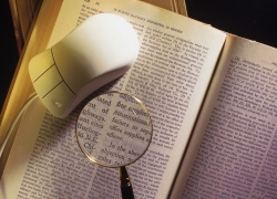 Mouse and magnifying glass on book