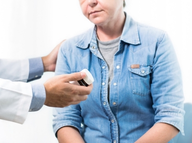 Physician talking with female patient and giving medication, photo by Atstock Productions/Adobe Stock