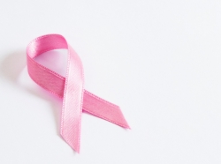 Pink breast cancer awareness ribbon on white background