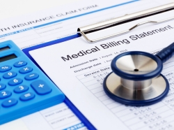 Calculator, medical billing statement on a clipboard, and stethoscope