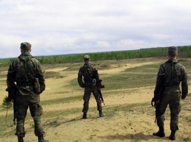 three NATO soldiers on a range