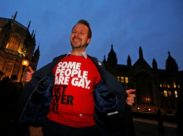 A campaigner demonstrates for a 'yes' vote to allow gay marriage, outside Parliament in London, February 5, 2013
