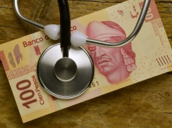 A stethoscope on Mexican pesos