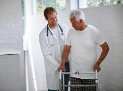A doctor and a senior patient using a walker