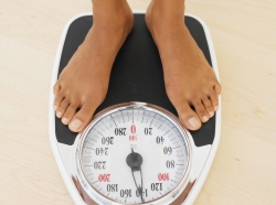 Close-up of a person standing on a bathroom scale