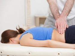Chiropractor working on woman's back