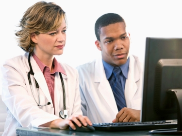 two doctors looking at a computer monitor