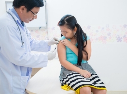 Doctor vaccinating little girl