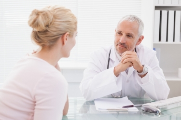 A doctor consults with his patient
