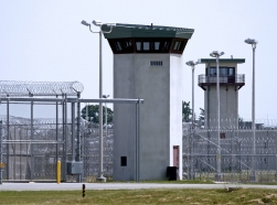 A prison fence and guard tower