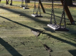 Close up of an empty swing set in a public park