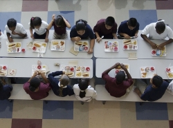 Students eating lunch in a school cafeteria
