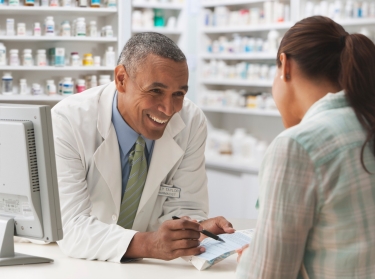 Pharmacist discussing prescription with customer