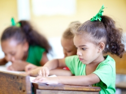 Preschool children sitting at desks in a classroom