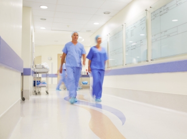 Medical professionals walking through a hospital corridor