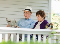 An older couple reading on a porch