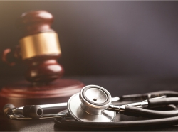 Stethoscope in the foreground, gavel in the background, photo by artisteer/Getty Images