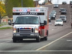 Ambulance with lights on driving down the highway, photo by ARHIT/Adobe Stock