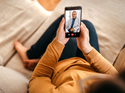 Woman having online consultation with doctor on a smartphone