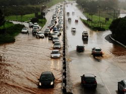 Motorists driving through water on a flooded highway. Photo by brazzo / Getty Images