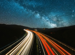 A highway at night under a starry sky