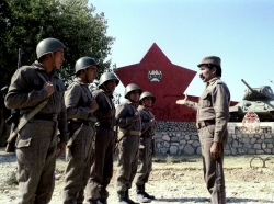 Officer giving instructions to young Afghan soldiers