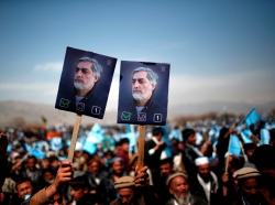 Supporters of Afghan presidential candidate Abdullah Abdullah hold posters of him during an election rally in Parwan province, northern Afghanistan, March 20, 2014
