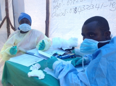 Government health workers administering blood tests for the Ebola virus in Kenema, Sierra Leone, June 2014
