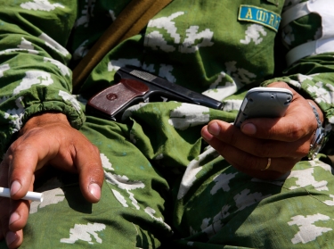 A pro-Russian rebel sends messages over his smartphone in the eastern Ukrainian town of Slaviansk, May 16, 2014
