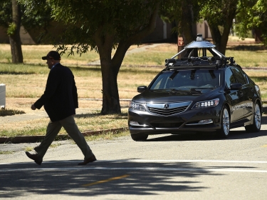 An autonomous version of Acura's RLX Sport Hybrid SH-AWD stops for a simulated pedestrian crossing at carmaker Honda's testing grounds at the GoMentum Station autonomous vehicle test facility in Concord, California, June 1, 2016