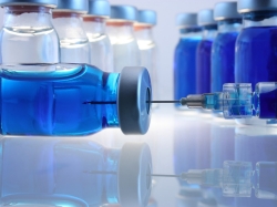 Pharmaceutical bottles and a syringe in a laboratory