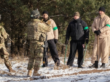U.S. soldiers serving with deterrence forces perform a scenario-based situation exercise with Polish soldiers acting as civilians near the Bemowo Piskie Training Area, Poland, February 6, 2018