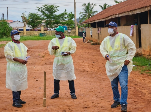 Staff members of the Lagos State Environmental Protection Agency promote social distancing at the Ikorodu Community School in Lagos, Nigeria