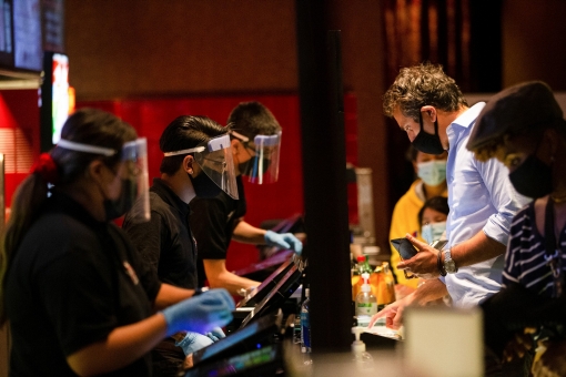 Moviegoers buy concessions before the movie Godzilla vs. Kong on the reopening day of the TCL Chinese theatre in Los Angeles, California, March 31, 2021