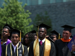 Graduates of The City College of New York stand at their commencement ceremony in Manhattan on May 31, 2019, photo by Gabriela Bhaskar/Reuters