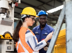 African American male and female industrial engineering in safety uniform, photo by amorn/AdobeStock