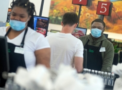 Corner Market cashier Effren Luckett (right) wears a mask while serving customers that don't always do the same in Jackson, Mississippi, October 26, 2021, photo by Barbara Gauntt/USA Today via Reuters
