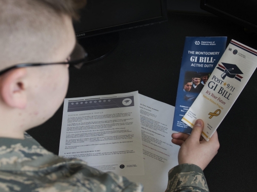 Airman Dalton Shank reads pamphlets on the Montgomery GI Bill and the Post-9/11 GI Bill, Minot Air Force Base, N.D., March 10, 2017