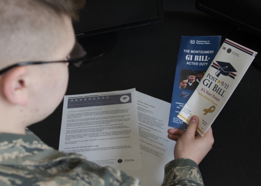 Airman Dalton Shank reads pamphlets on the Montgomery GI Bill and the Post-9/11 GI Bill, Minot Air Force Base, N.D., March 10, 2017