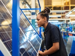 An engineer inspecting newly manufactured solar panels in company. Woman quality engineer examining solar panels in factory. Photo by alvarez / Getty Images