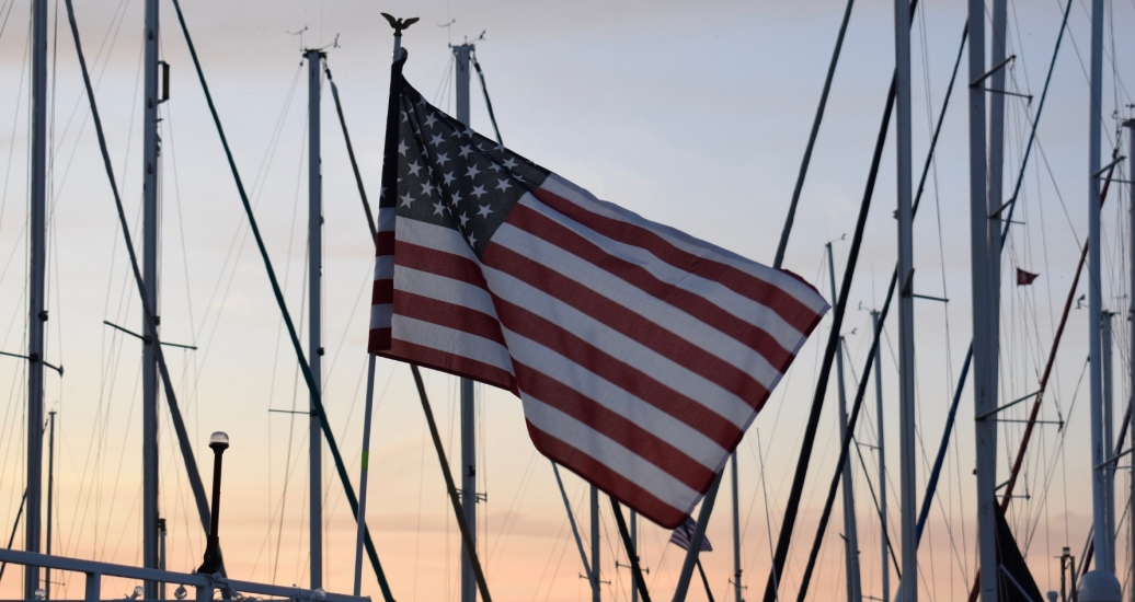 An American flag waving at sunset