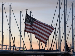 An American flag waving at sunset, photo by Emily Sisson/Getty Images