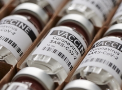 Bottles containing a vaccine for SARS-CoV-2, photo by Max Rode/Adobe Stock