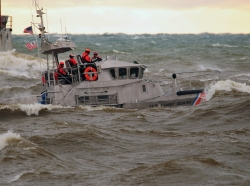 Crew members from Coast Guard Station Grand Haven, Michigan aboard a 47-foot Motor Life Boat train during a period of heavy weather